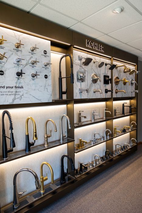 Kohler Faucet and Fixture Display | Horsch & Miller Slinger WI Kohler showroom wall displaying faucets and shower fixtures in multiple finishes at Horsch & Miller
